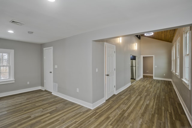 spare room featuring dark hardwood / wood-style flooring, vaulted ceiling, and wooden ceiling