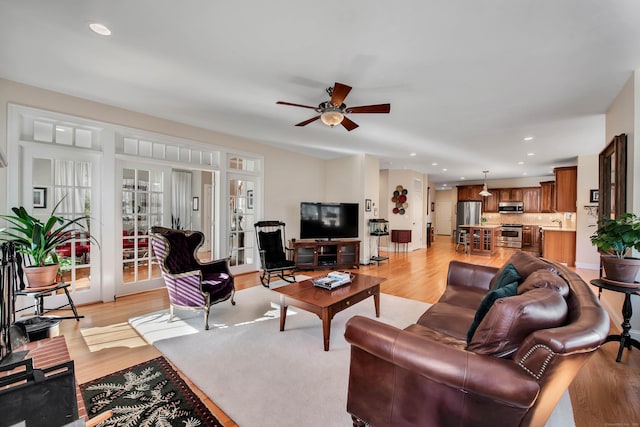 living area with recessed lighting, light wood-style floors, and ceiling fan