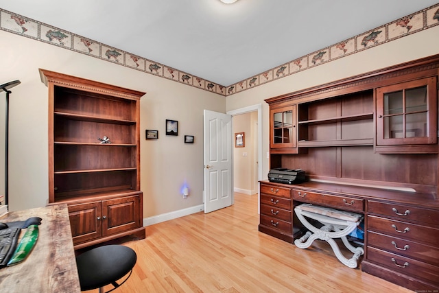 home office with baseboards and light wood finished floors