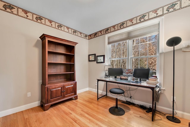 office area featuring light wood-type flooring and baseboards