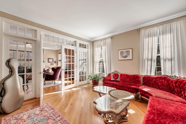 living area featuring french doors, crown molding, and wood finished floors