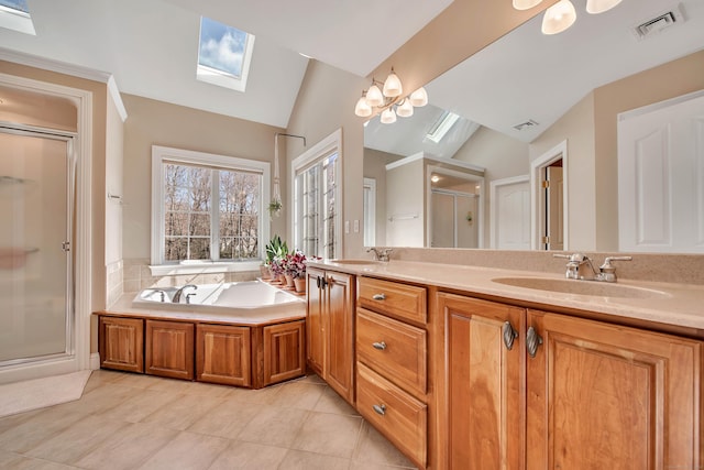 full bathroom featuring a sink, visible vents, lofted ceiling with skylight, and a stall shower