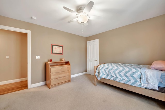 bedroom with ceiling fan, baseboards, and light carpet