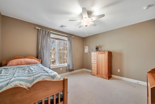 bedroom with visible vents, baseboards, light colored carpet, and ceiling fan