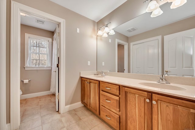 full bath featuring a sink, visible vents, and double vanity