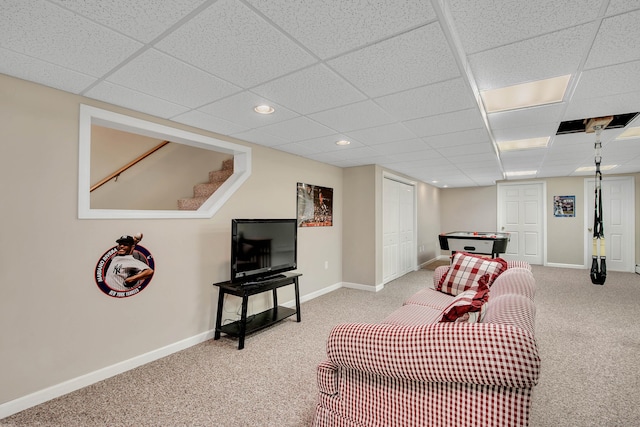 carpeted living room featuring a drop ceiling, recessed lighting, stairs, and baseboards