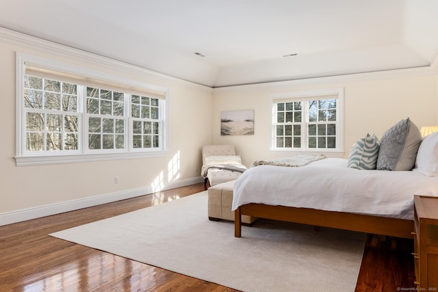 bedroom with wood finished floors and baseboards