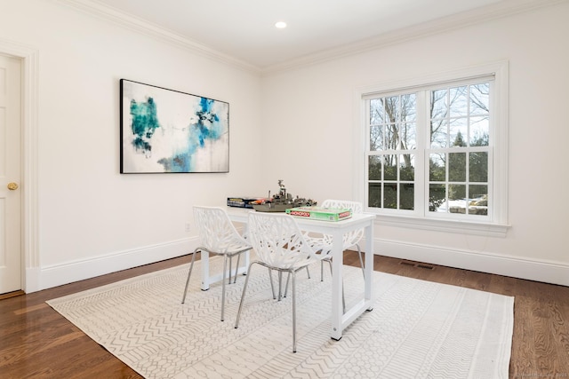 dining room featuring baseboards, visible vents, wood finished floors, crown molding, and recessed lighting