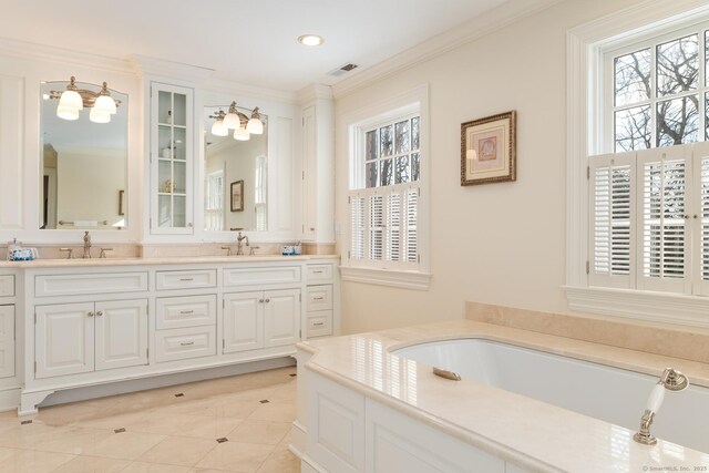 full bath with a sink, visible vents, and crown molding