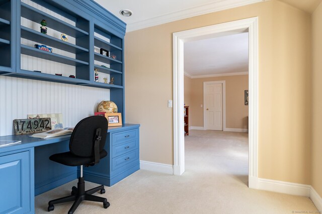 office area with light carpet, baseboards, built in study area, and crown molding