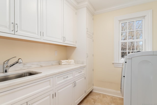 washroom with washer / dryer, ornamental molding, a sink, and light tile patterned floors