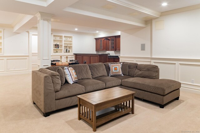 living room featuring recessed lighting, light carpet, a decorative wall, ornamental molding, and decorative columns