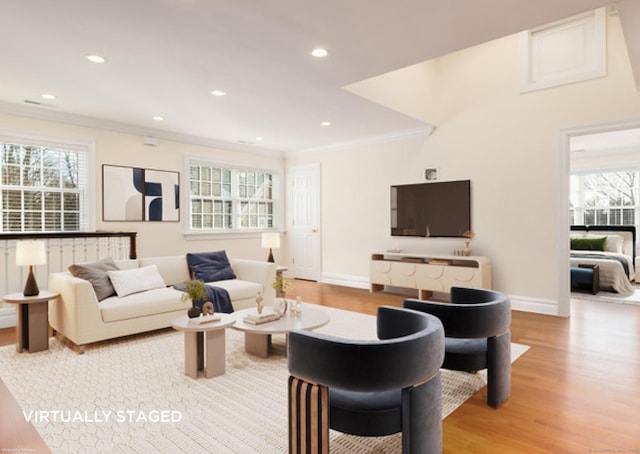 living room featuring light wood-style floors, recessed lighting, crown molding, and baseboards