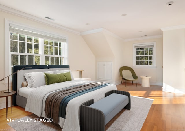 bedroom with baseboards, visible vents, wood finished floors, and ornamental molding