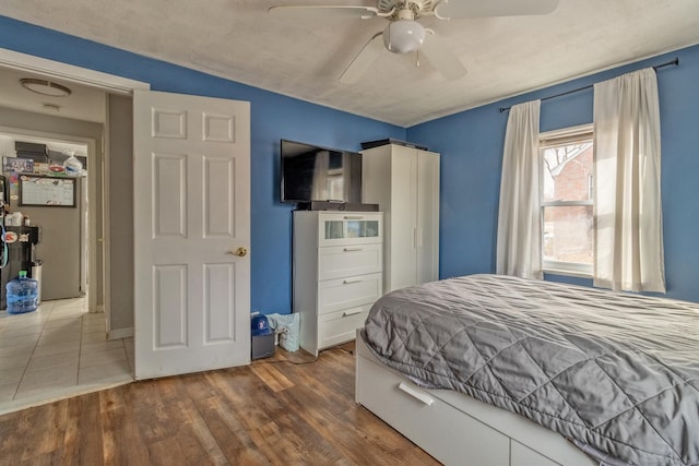 bedroom with ceiling fan and dark hardwood / wood-style floors