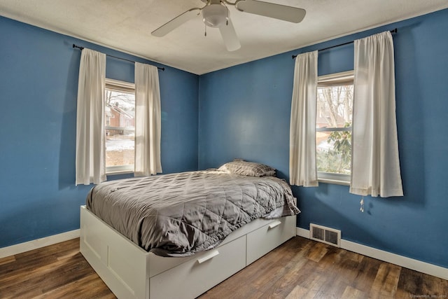 bedroom featuring ceiling fan and dark hardwood / wood-style floors