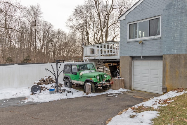 exterior space featuring a wooden deck and a garage