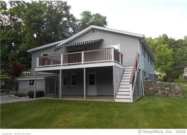 rear view of house featuring a yard and a patio area