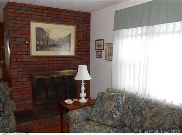 living room featuring a fireplace and a wealth of natural light