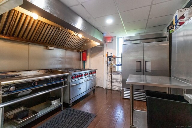 175 Main St, Winchester, CT 06098 - kitchen with a drop ceiling, premium appliances, dark wood-type flooring, and exhaust hood