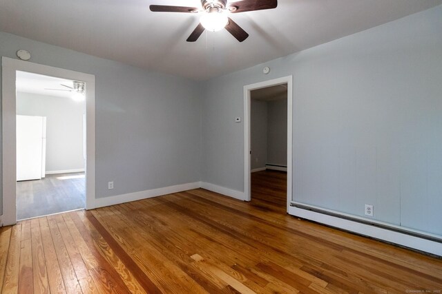 175 Main St, Winchester, CT 06098 - unfurnished room featuring a baseboard heating unit, hardwood / wood-style floors, and ceiling fan
