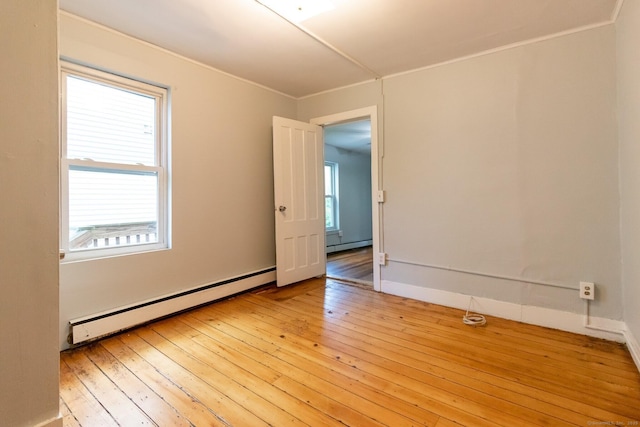 175 Main St, Winchester, CT 06098 - empty room with a baseboard heating unit and light hardwood / wood-style floors