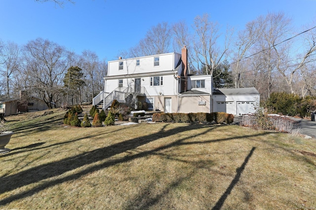 back of house featuring a yard and a garage