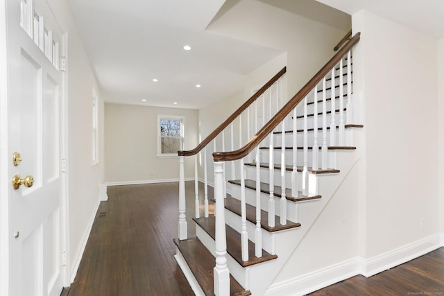 stairs featuring hardwood / wood-style floors