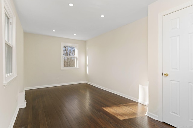 unfurnished room with recessed lighting, dark wood finished floors, and baseboards