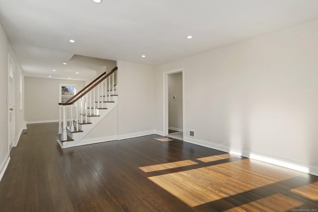 spare room featuring recessed lighting, visible vents, stairway, hardwood / wood-style floors, and baseboards