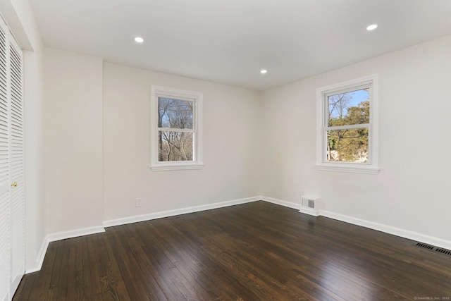 unfurnished bedroom featuring recessed lighting, dark wood-style flooring, visible vents, and baseboards