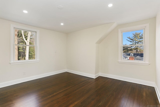 bonus room with dark wood-style floors, recessed lighting, and baseboards