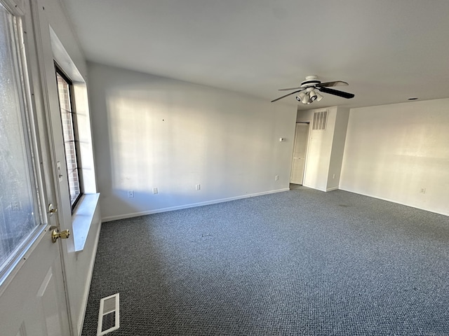 carpeted spare room with ceiling fan and a healthy amount of sunlight