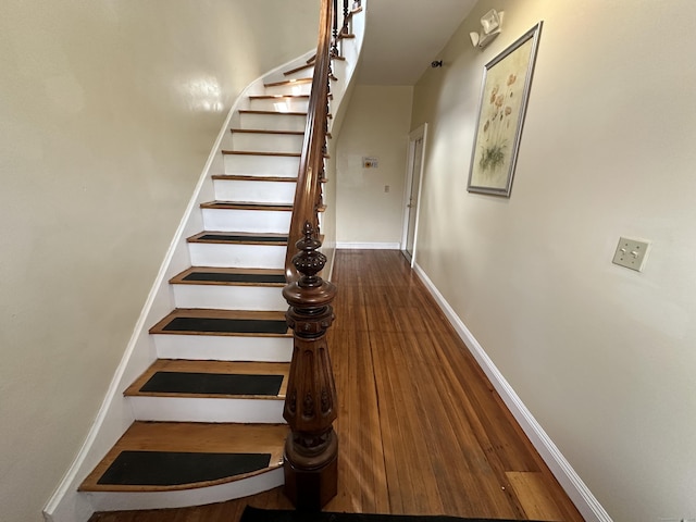 stairway featuring hardwood / wood-style floors