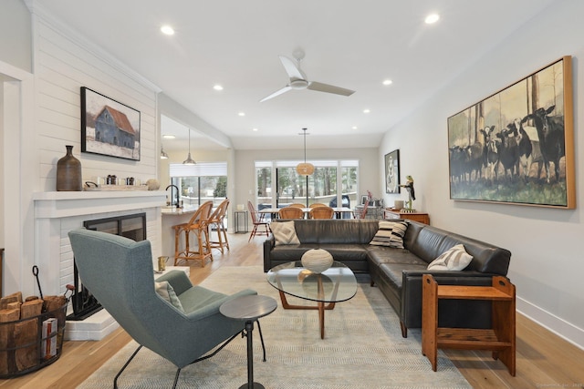 living room with light hardwood / wood-style floors and ceiling fan