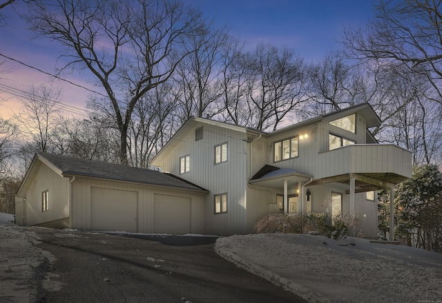 view of front of house with a garage and aphalt driveway