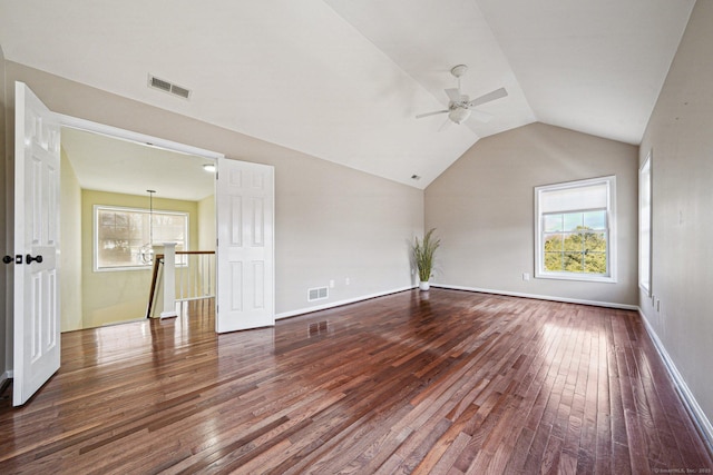 unfurnished living room featuring ceiling fan, wood-type flooring, vaulted ceiling, and plenty of natural light