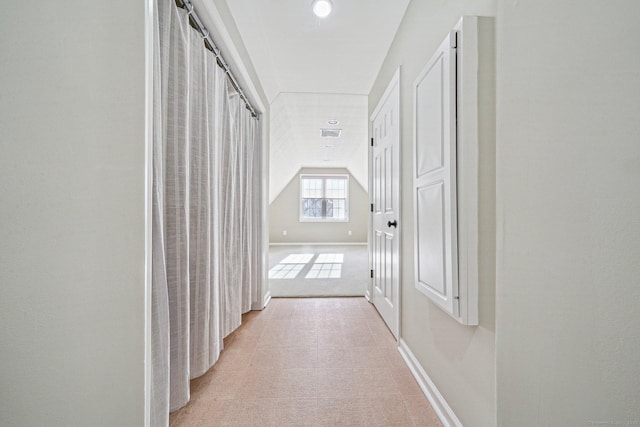 hallway featuring vaulted ceiling