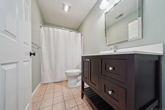 bathroom featuring vanity, toilet, and tile patterned flooring