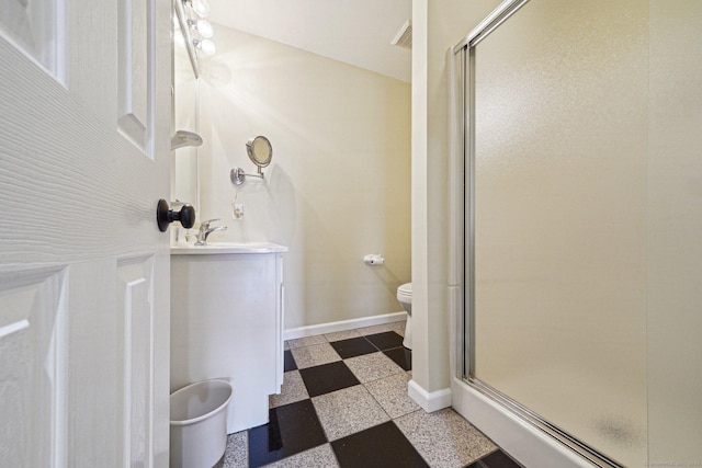 bathroom with an enclosed shower, vanity, and toilet