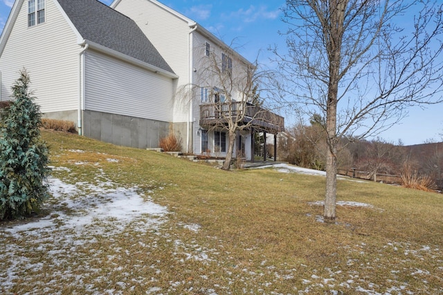 exterior space featuring a deck and a lawn