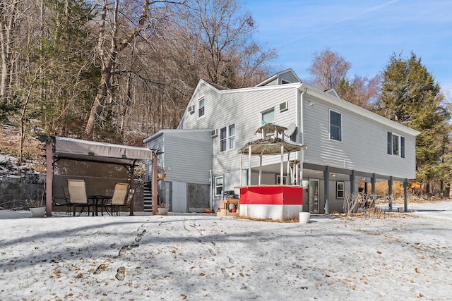 view of snow covered back of property