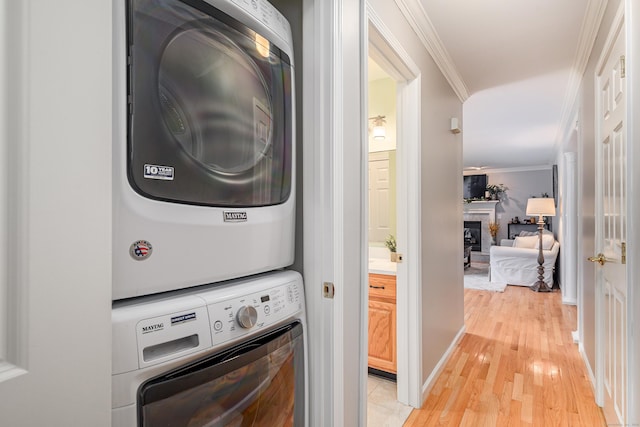 48 Bear Mountain Rd, Danbury, CT 06811 - washroom featuring estacked washer and dryer, ornamental molding, light wood-style floors, and a fireplace