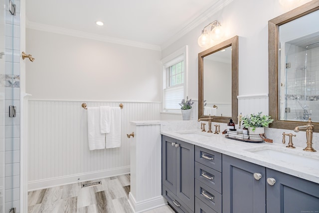48 Bear Mountain Rd, Danbury, CT 06811 - bathroom with double vanity, ornamental molding, a stall shower, wainscoting, and wood finished floors