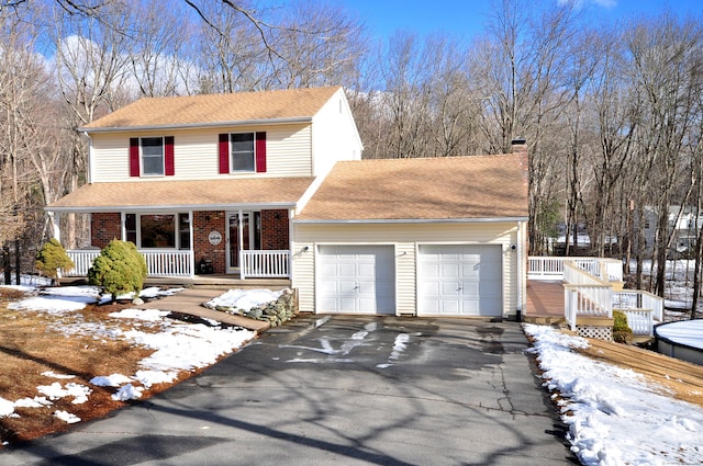 front of property featuring a garage and covered porch