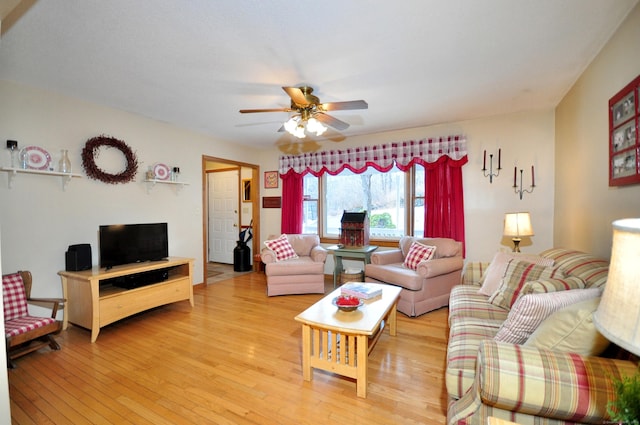 living room with ceiling fan and light hardwood / wood-style flooring