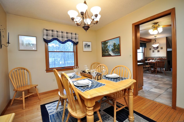 dining area featuring an inviting chandelier, plenty of natural light, and wood-type flooring