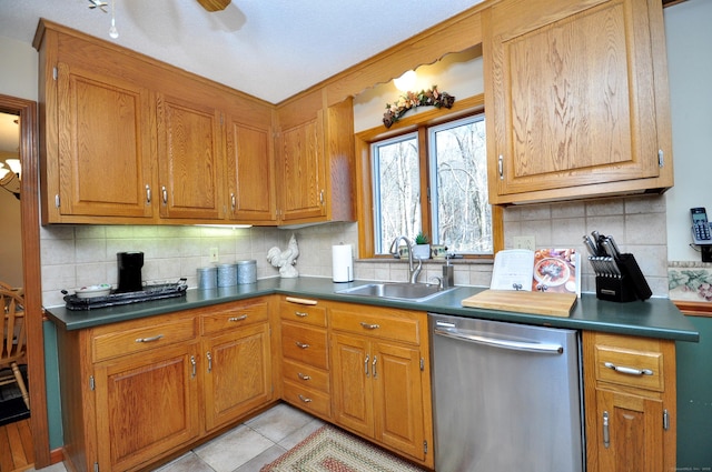 kitchen featuring sink, decorative backsplash, dishwasher, and light tile patterned flooring