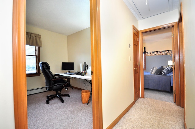 office area featuring light carpet and baseboard heating