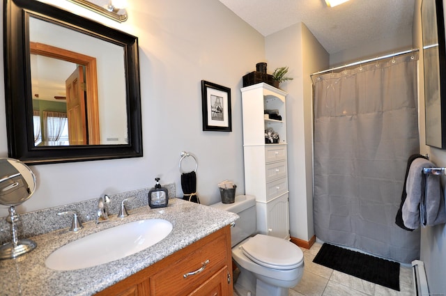 bathroom featuring a baseboard radiator, vanity, tile patterned floors, and toilet